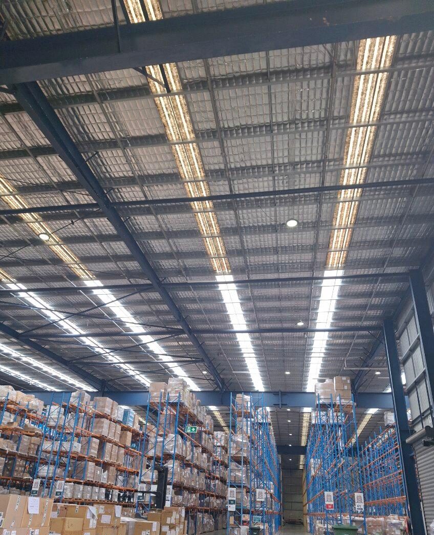 Commercial Ampelite skylight replacement for a factory in Dandenong showing a clear old‑versus‑new comparison e1774329122996